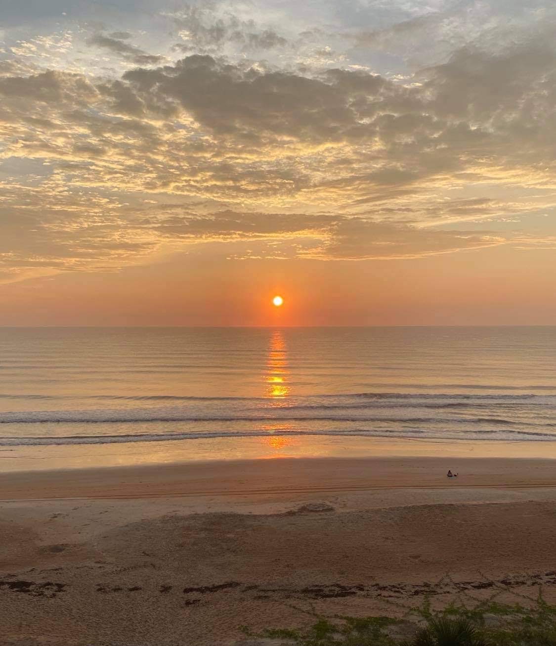 Golden sunrise over the Atlantic Ocean and beach at Surfside Club North